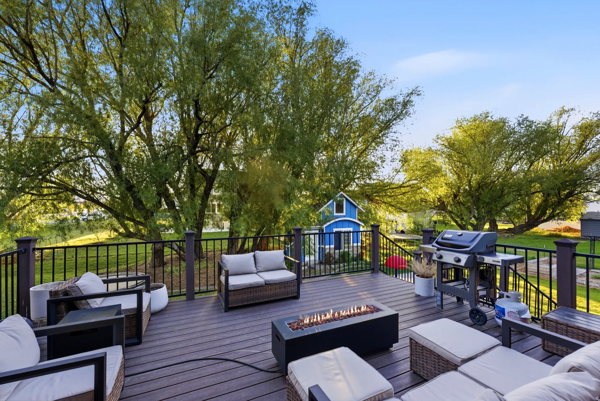 Spacious outdoor deck featuring composite decking and black metal railings