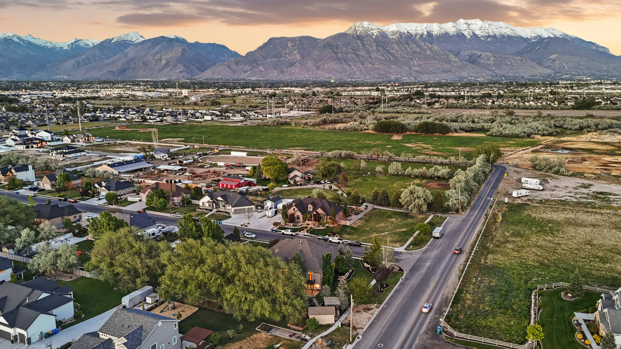 Expansive mountain range backdrop framing a residential neighborhood with mature trees