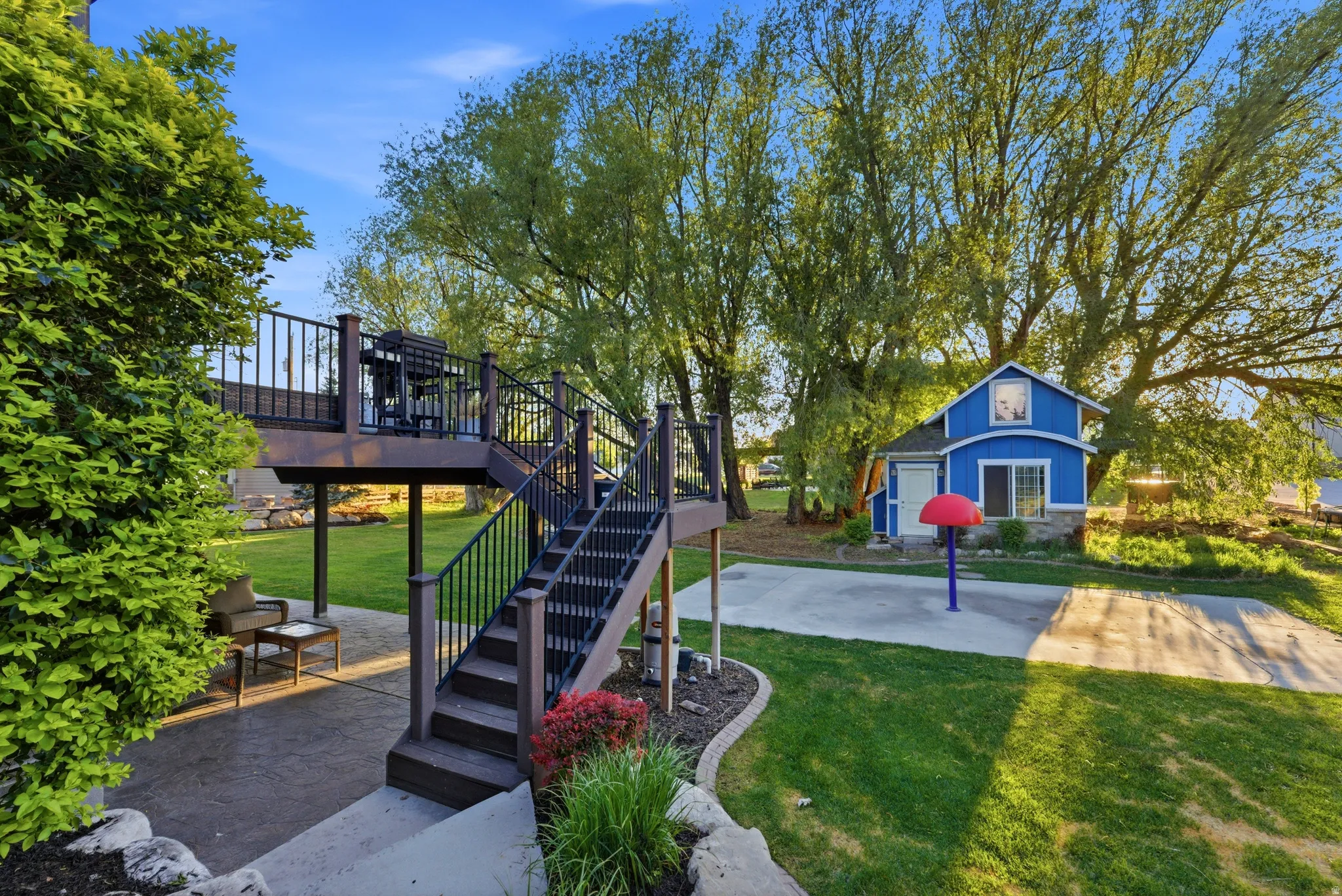 Two-story composite deck with dark railings and stairs