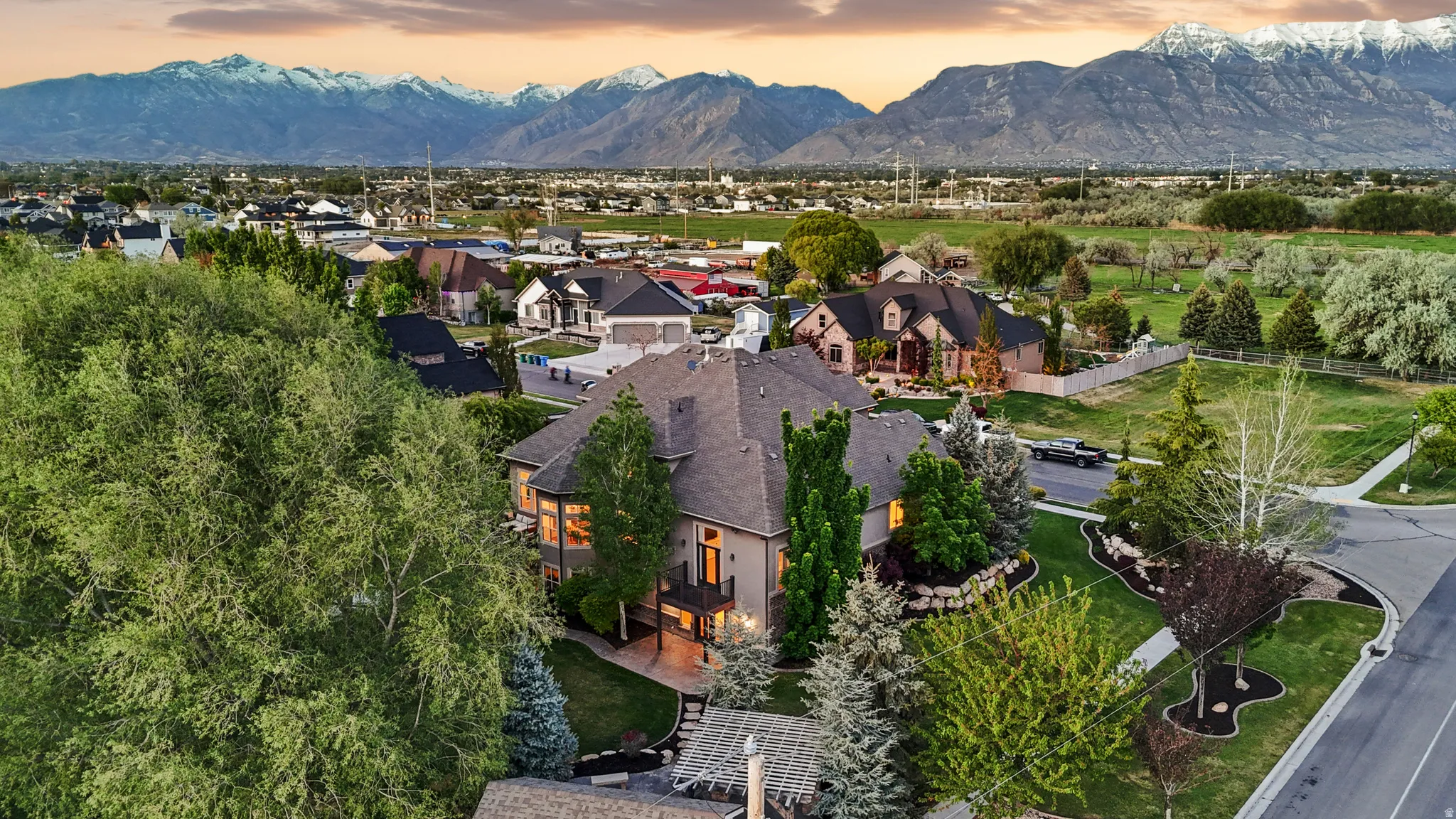 Expansive property featuring a mature landscape, paved driveway, and established neighborhood setting