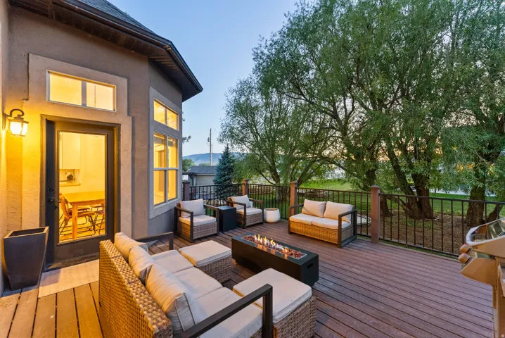 Spacious outdoor deck featuring composite decking and black metal railings