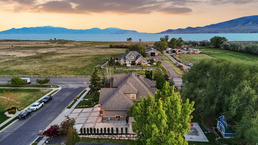Expansive property showcasing a large residential structure with a multi-gabled roof and a patterned concrete driveway