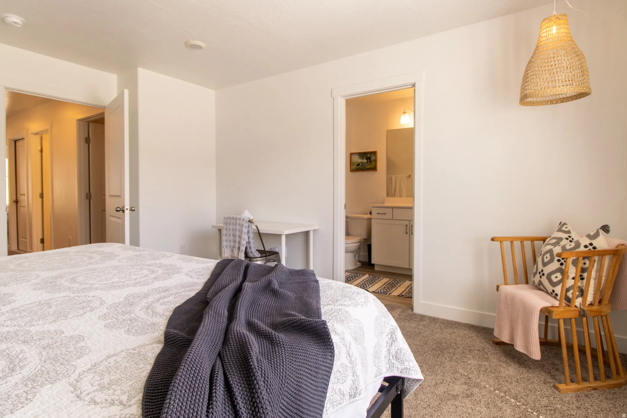 Spacious primary bedroom featuring recessed lighting, a large window that fills the space with abundant natural light, a private ensuite bath, and neutral carpet flooring
