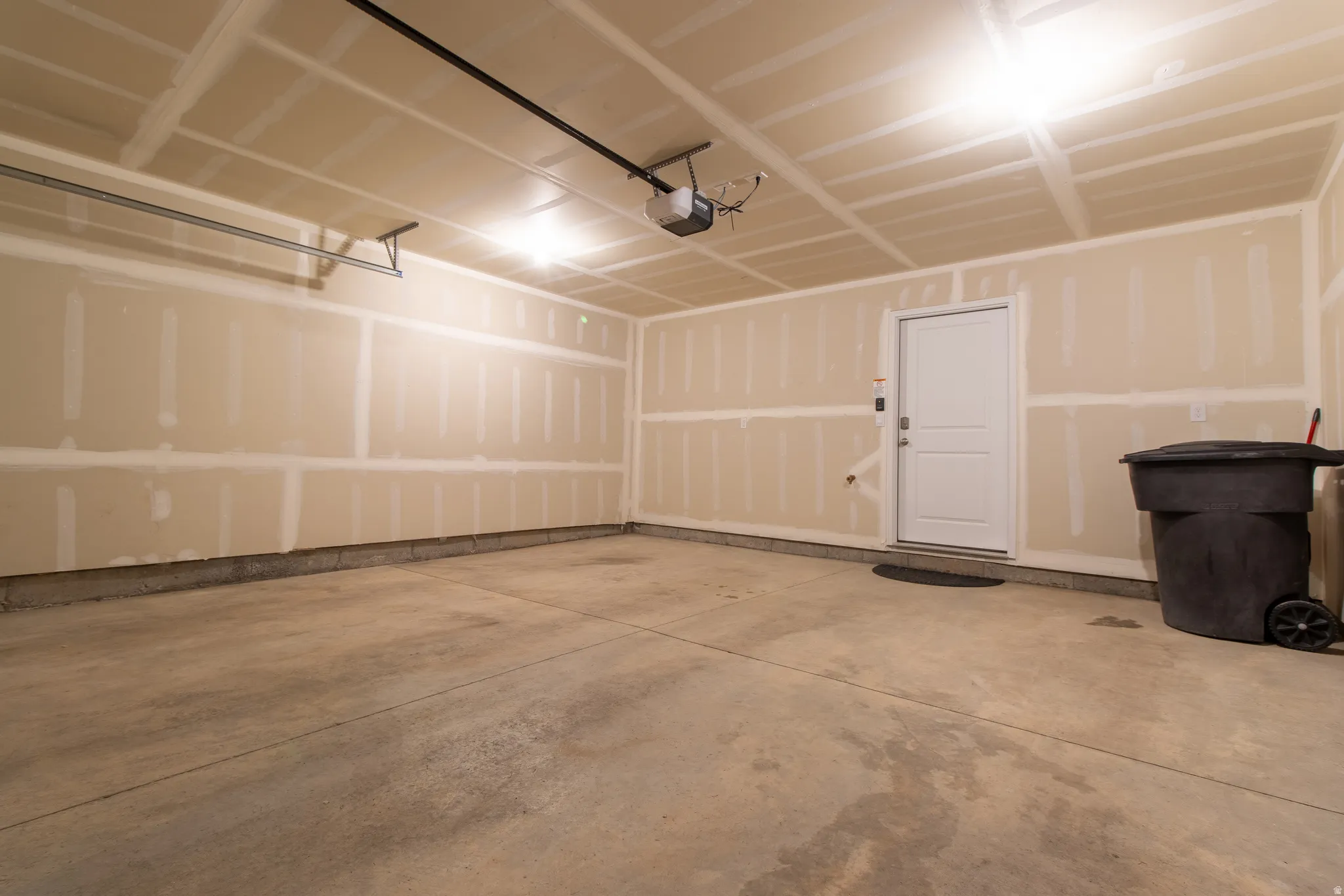 Spacious garage featuring concrete flooring,