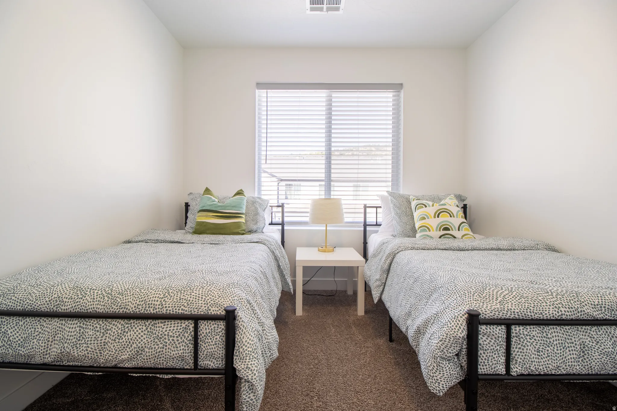 Good size bedroom with large window for natural light, high quality vinyl blinds