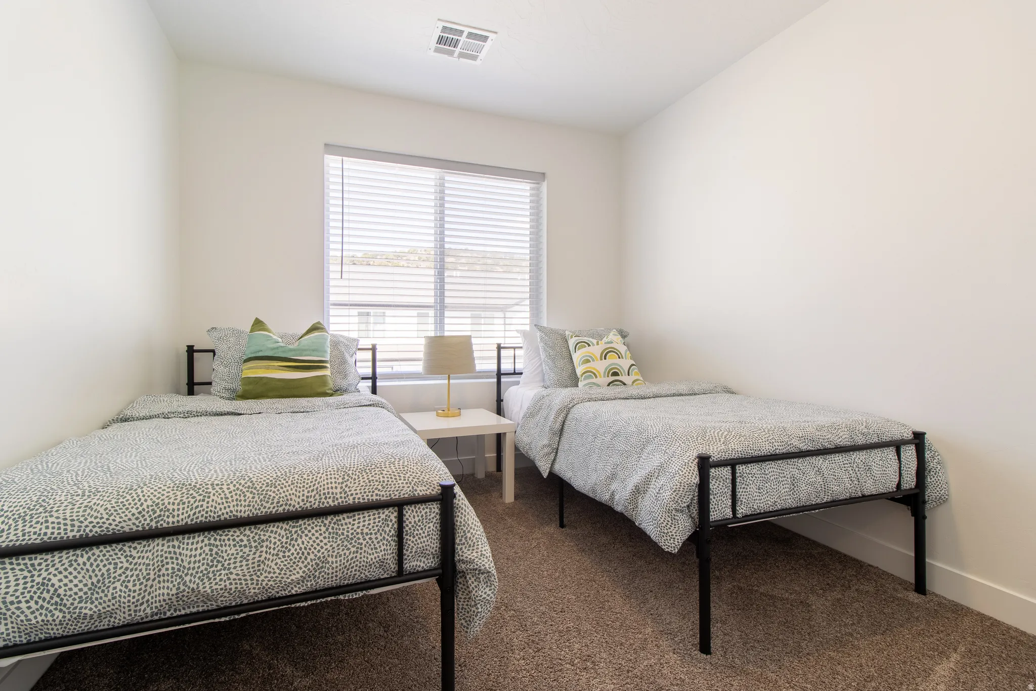 Good size bedroom with large window for natural light, high quality vinyl blinds