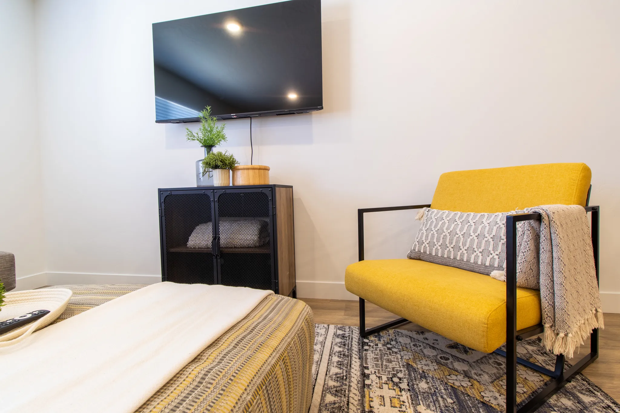 Bright open-concept living space featuring premium laminate flooring, recessed lighting