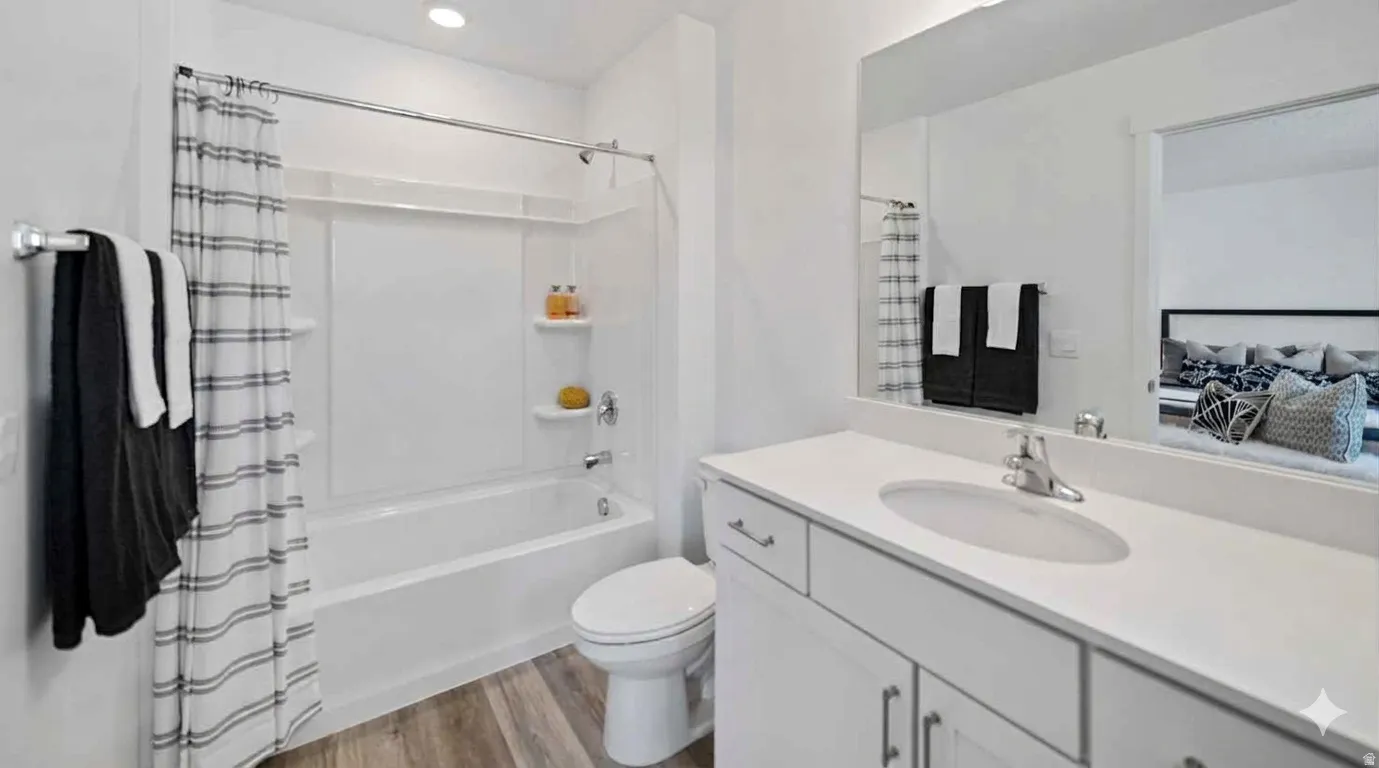 Bright and relaxing primary en suite full bathroom featuring quartz countertops, clean white shaker cabinets, and plenty of natural light