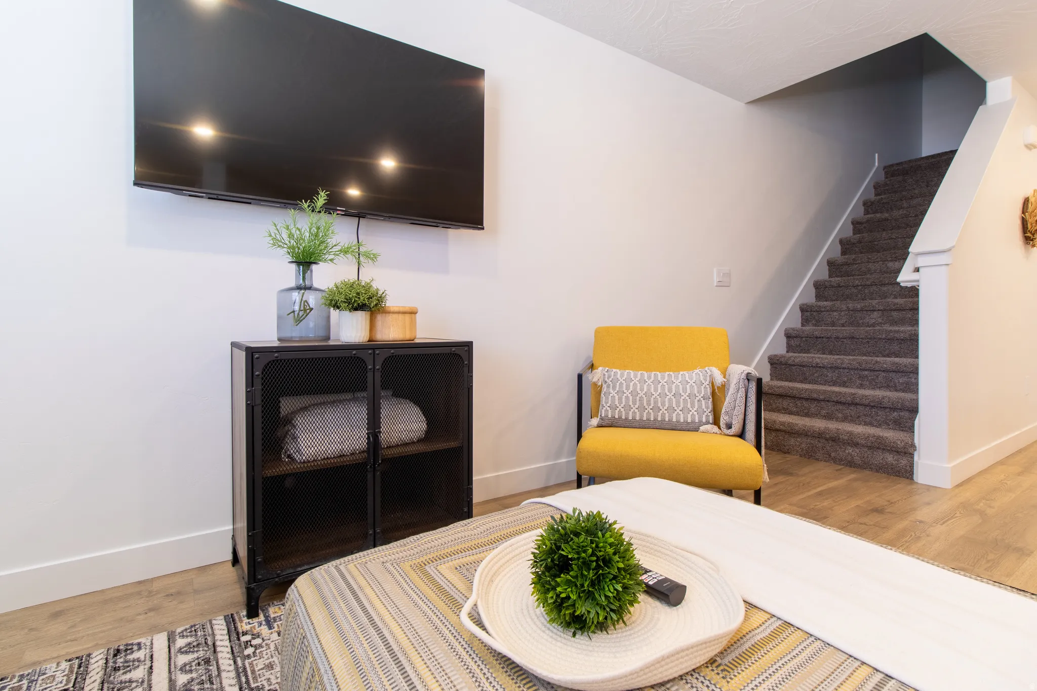 Bright open-concept living space featuring premium laminate flooring, recessed lighting, brings in plenty of natural light