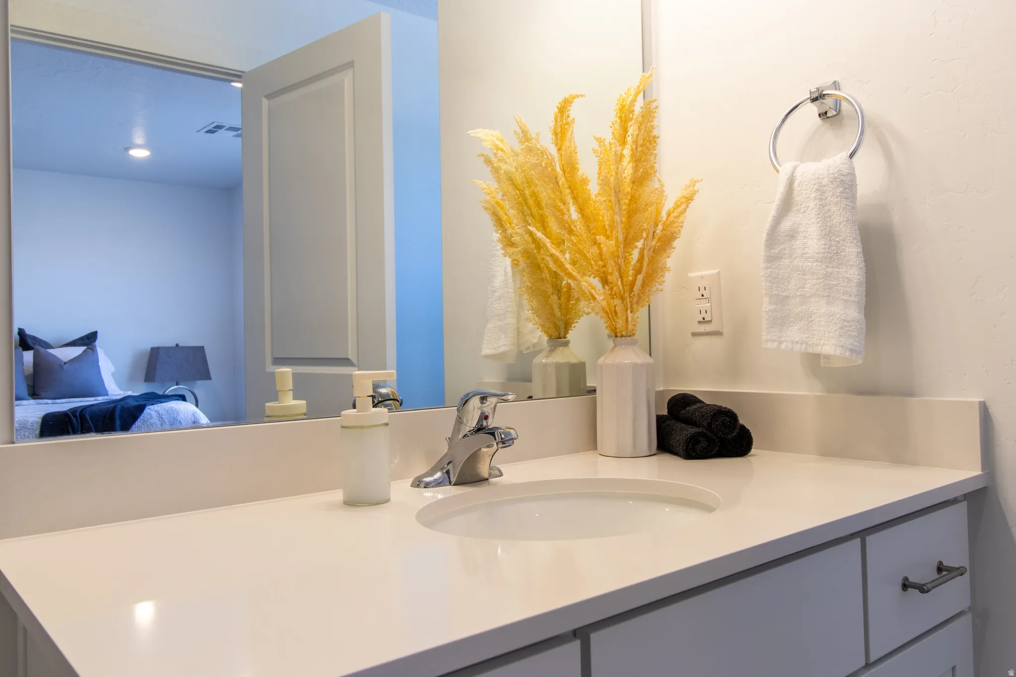 Bright and relaxing primary full en suite bathroom featuring quartz countertops, clean white shaker cabinets, and plenty of natural light.