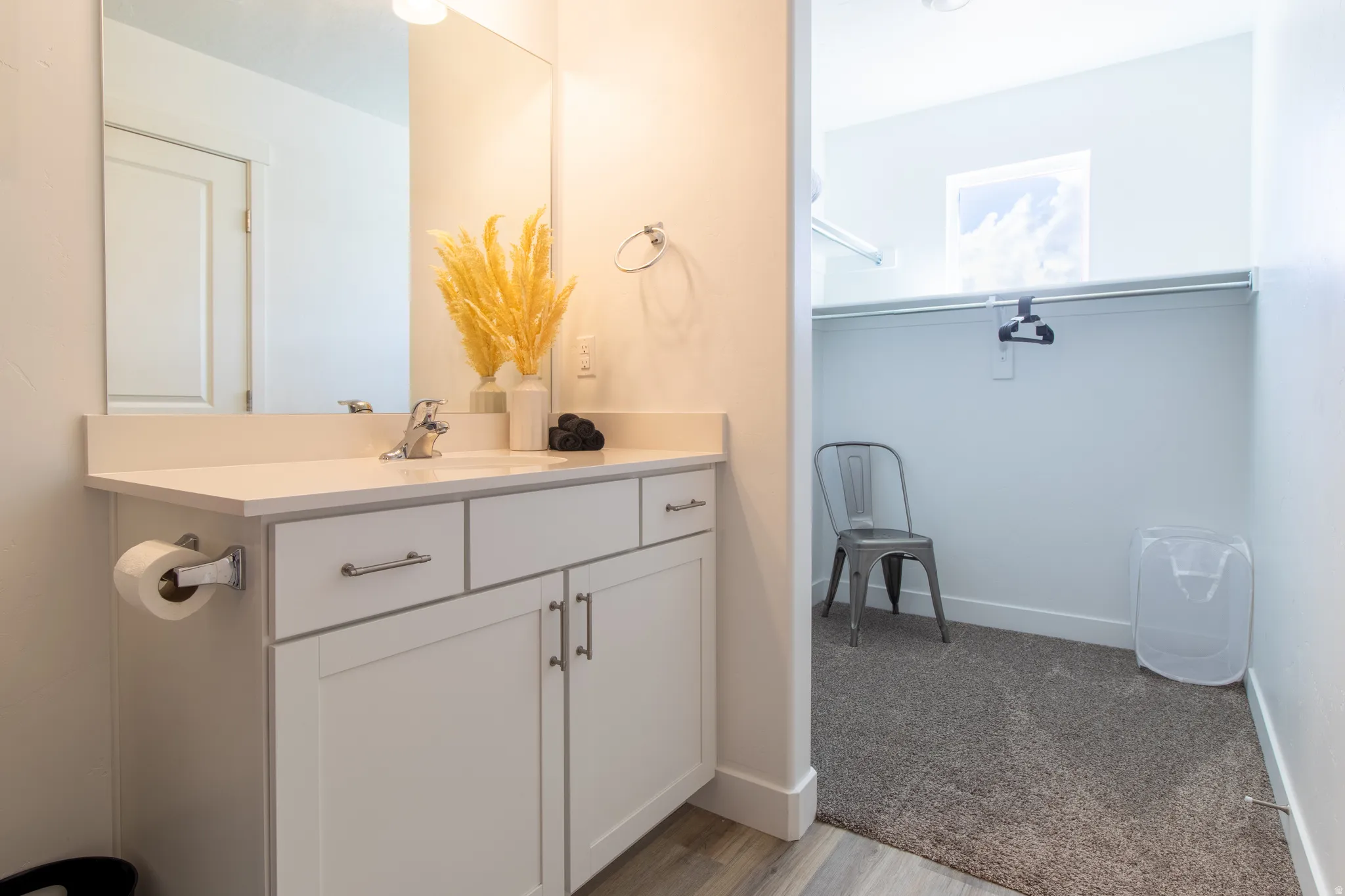Just off the primary bathroom is this spacious walk-in closet with a high window that brings in additional natural light
