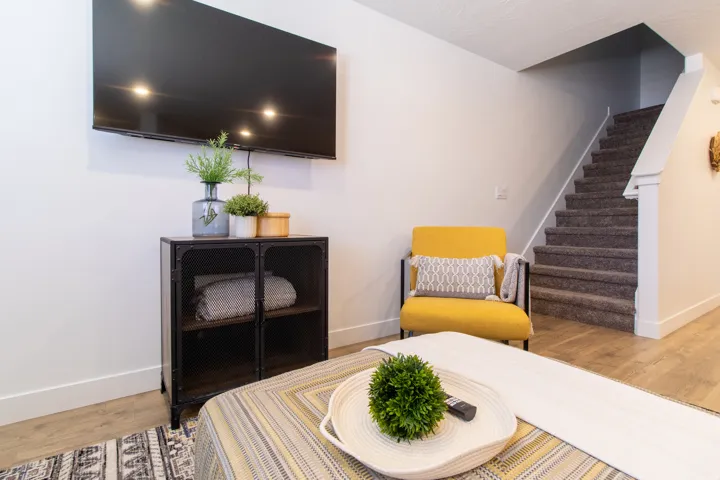 Bright open-concept living space featuring premium laminate flooring, recessed lighting, brings in plenty of natural light