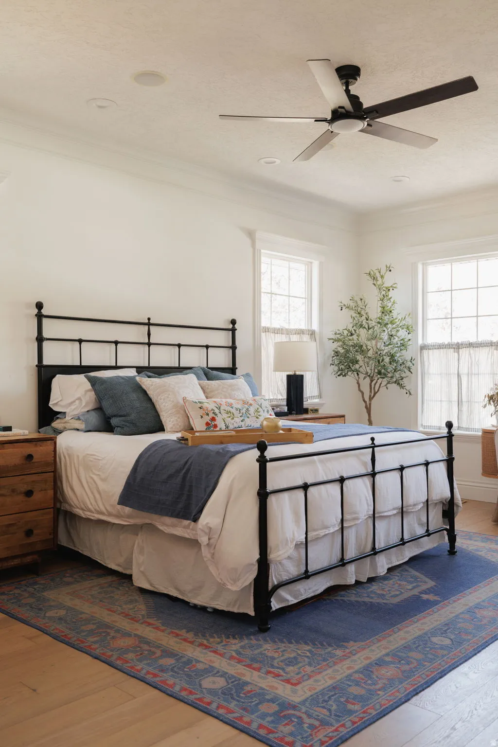 Bedroom featuring wood finished floors, multiple windows, ceiling fan, crown molding, and a textured ceiling
