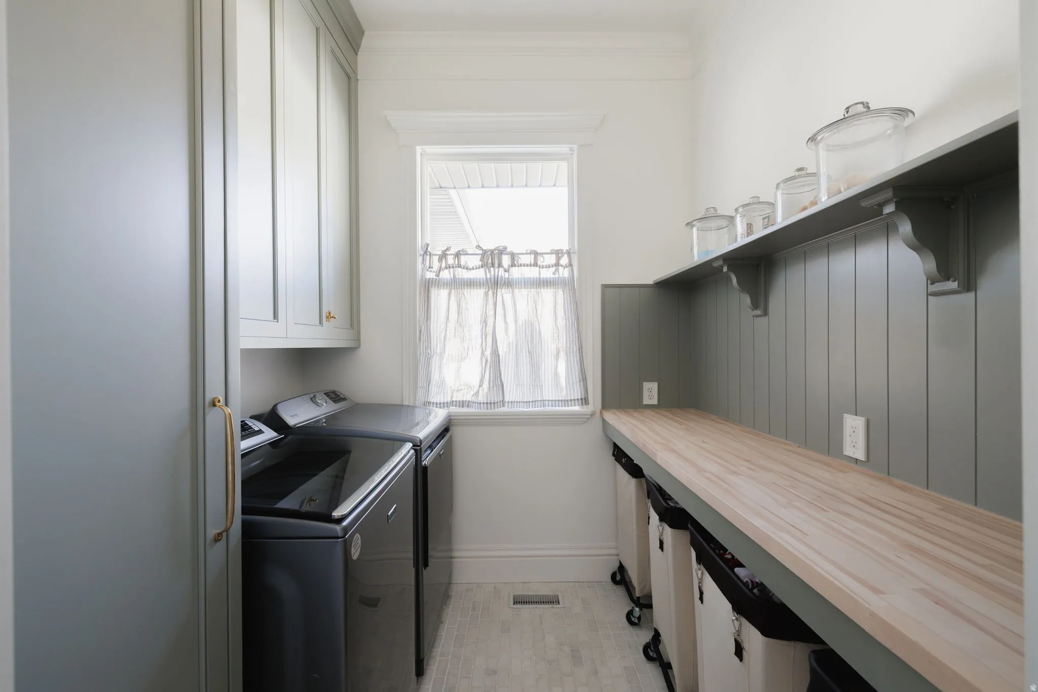 Laundry area featuring cabinet space and washer and clothes dryer