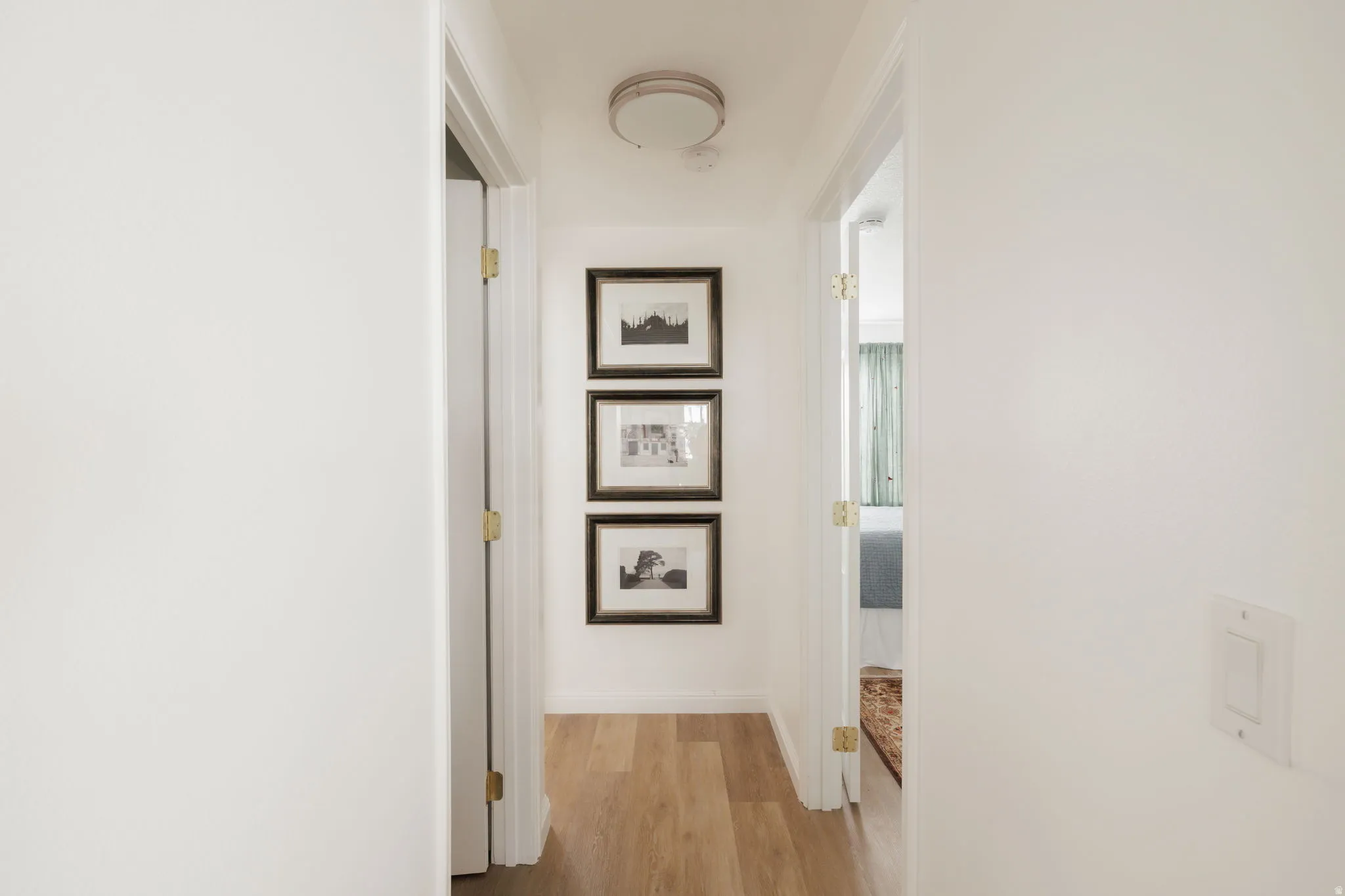 Hallway featuring light wood-style floors and baseboards