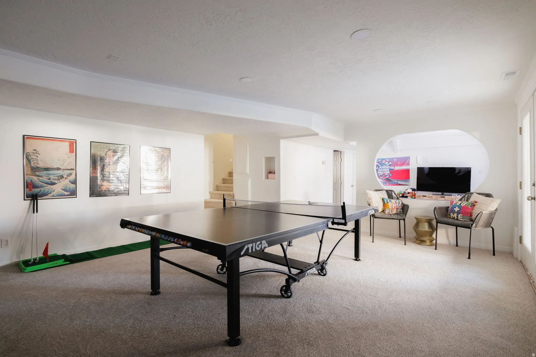 Game room featuring carpet floors and a textured ceiling