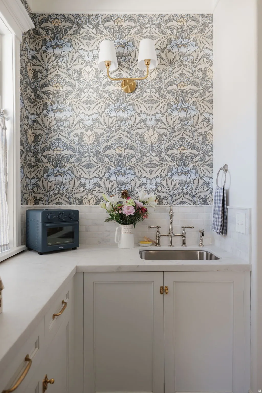 Bathroom featuring vanity and wallpapered walls