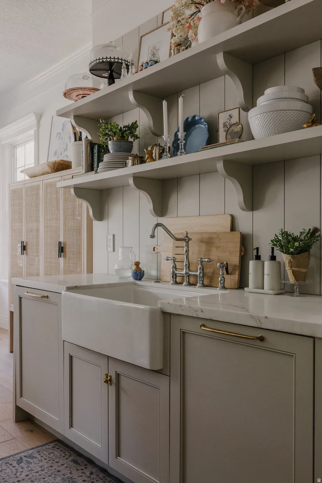 Bar featuring open shelves, light stone countertops, and gray cabinets
