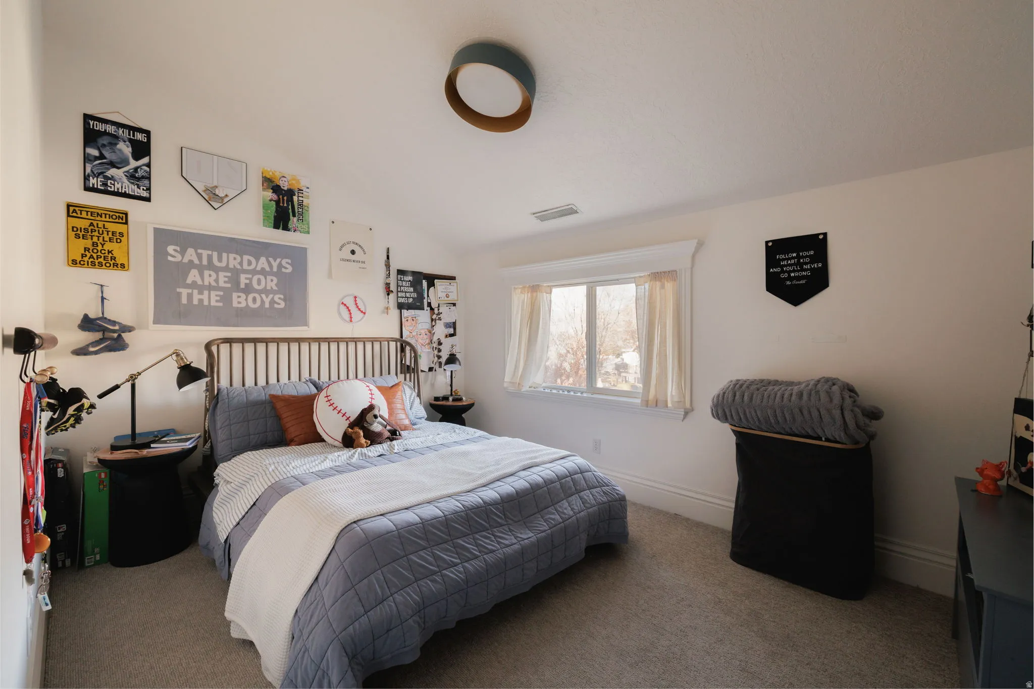 Carpeted bedroom with lofted ceiling and baseboards