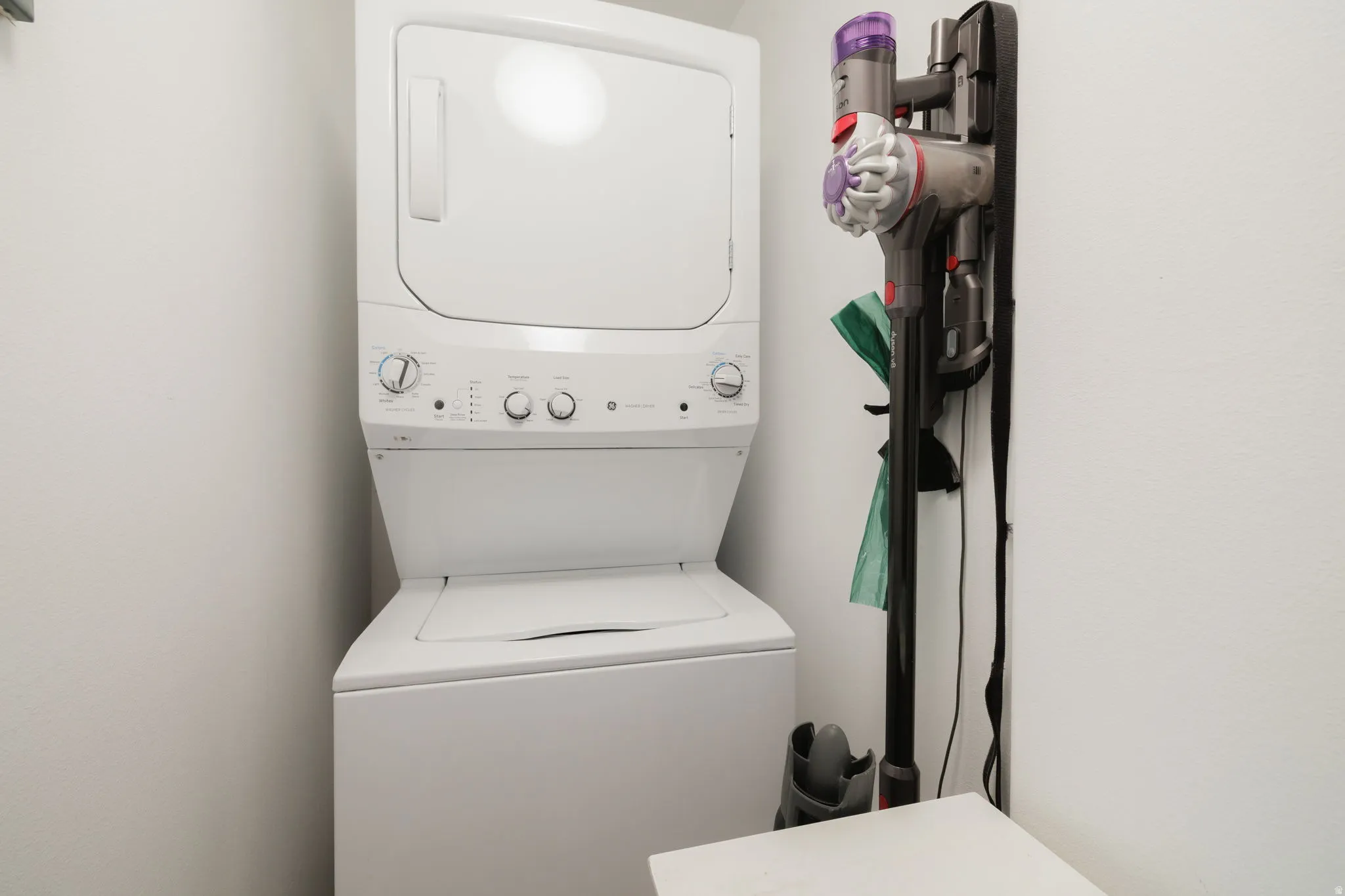 Laundry area featuring stacked washer / dryer