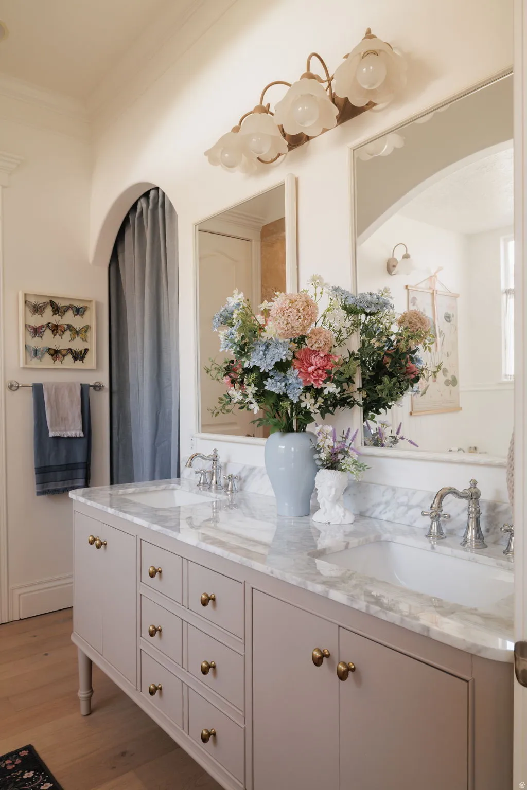 Full bathroom featuring double vanity, light wood-style floors, and crown molding