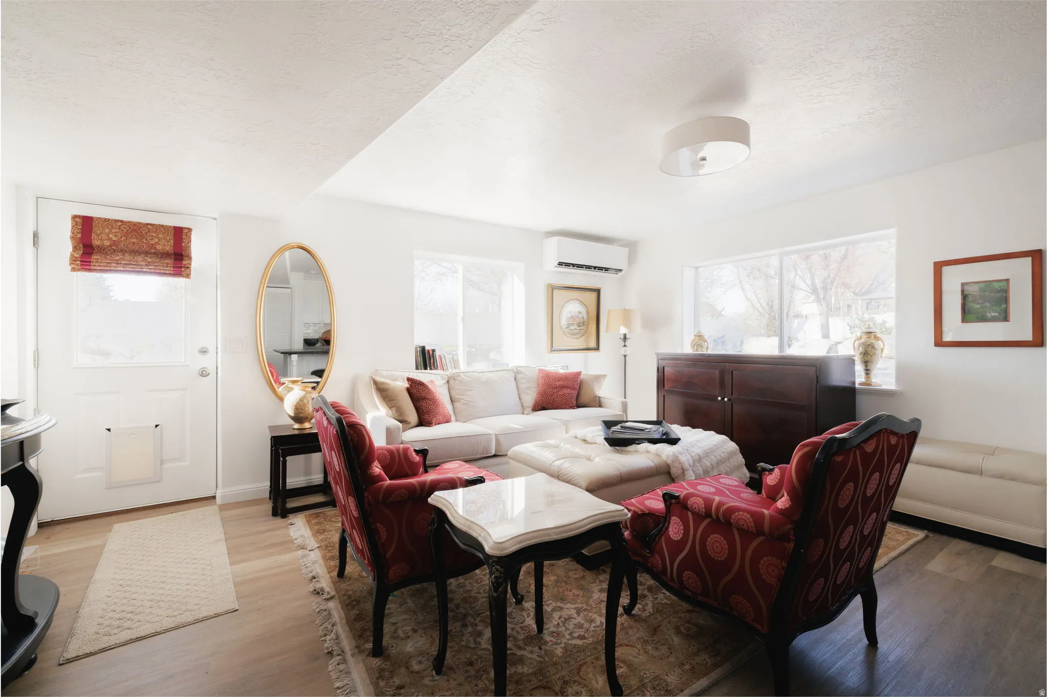 Living area with wood finished floors and a textured ceiling