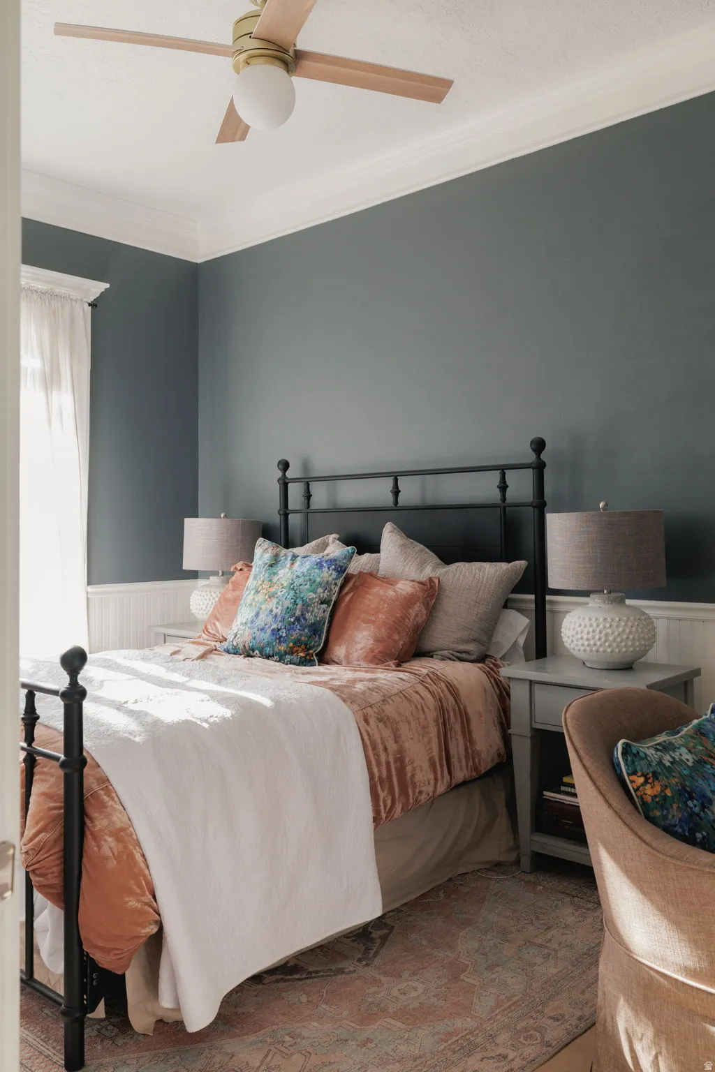 Bedroom with wainscoting, crown molding, ceiling fan, and wooden walls