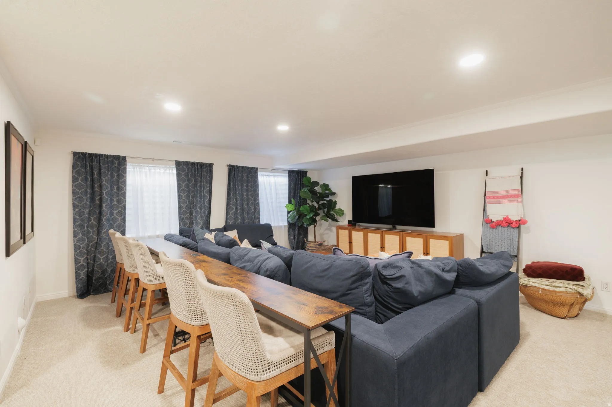 Living room with light colored carpet and recessed lighting