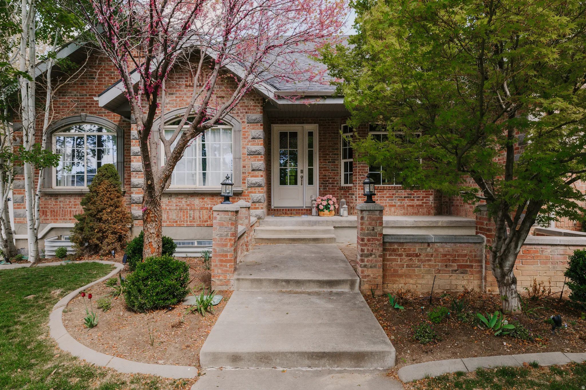 View of front facade featuring brick siding and a porch