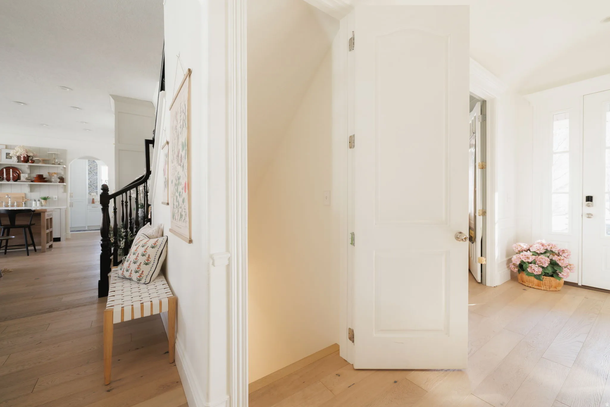 Foyer featuring light wood-type flooring and arched walkways