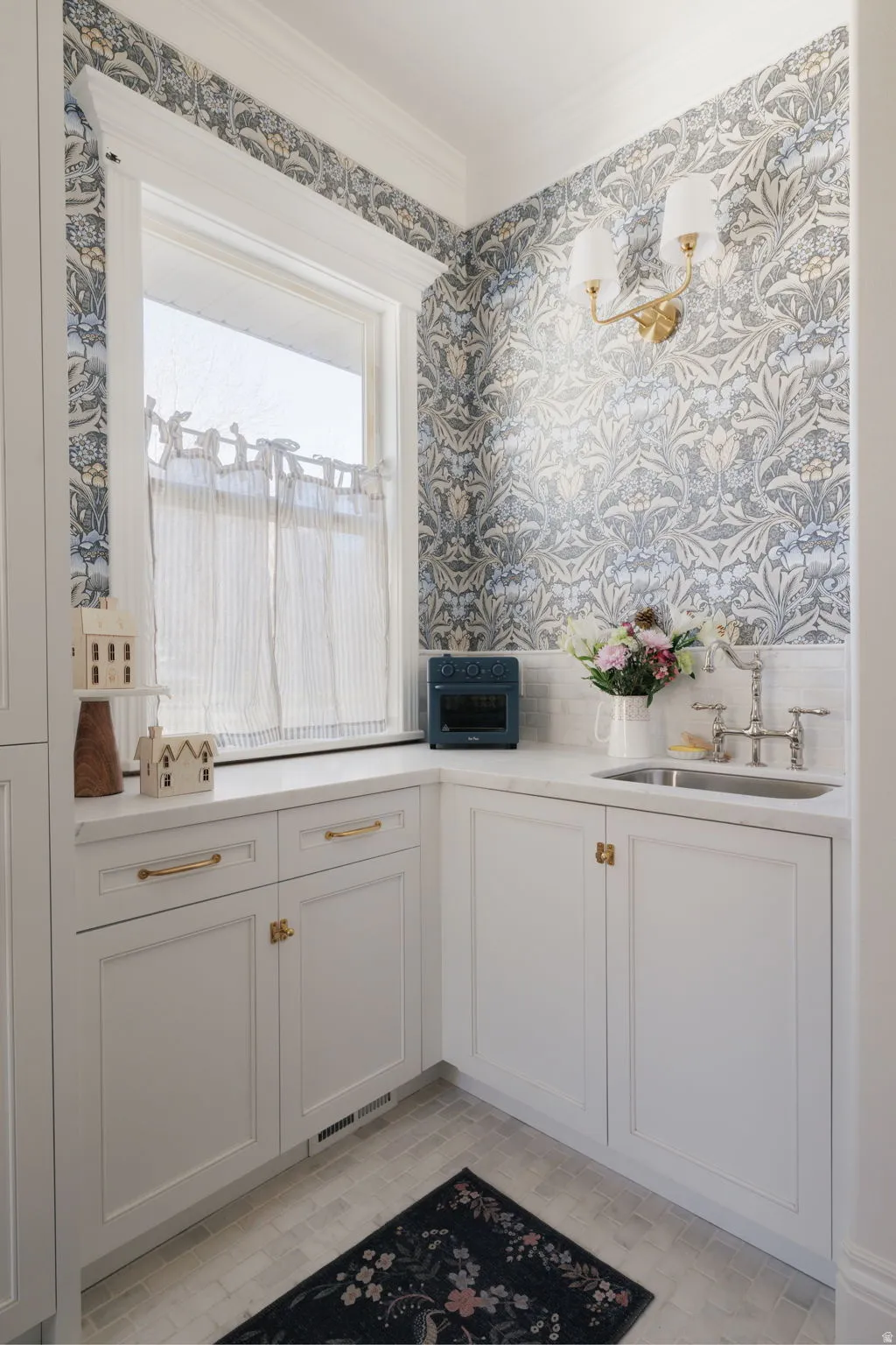 Bar area with wallpapered walls, white cabinetry, and ornamental molding