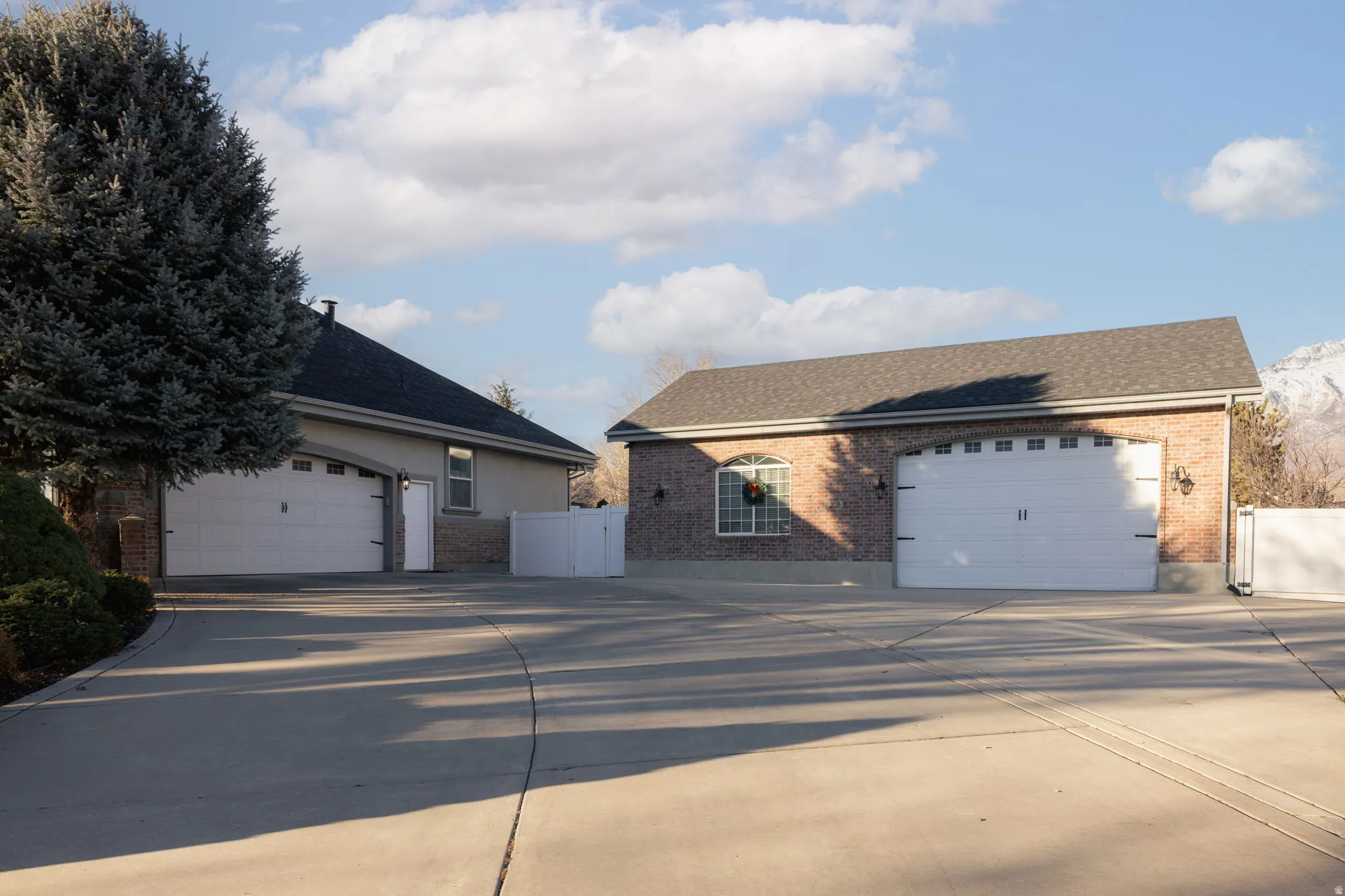 View of front facade featuring a shingled roof and brick siding