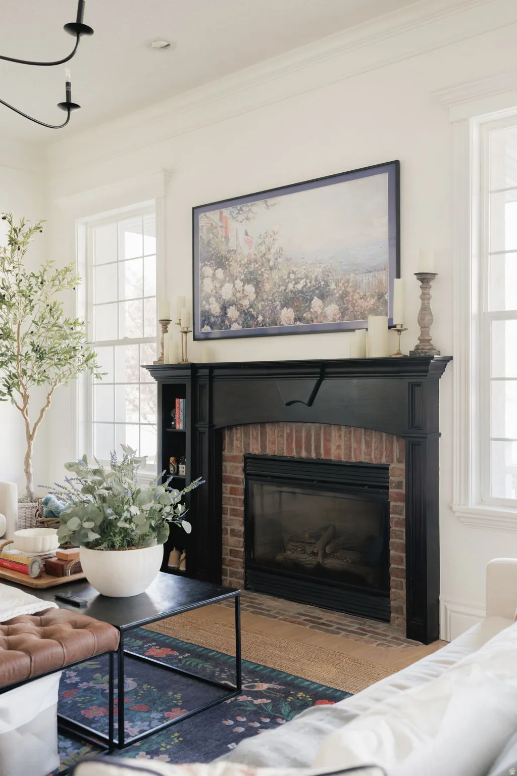Living room featuring a brick fireplace and ornamental molding