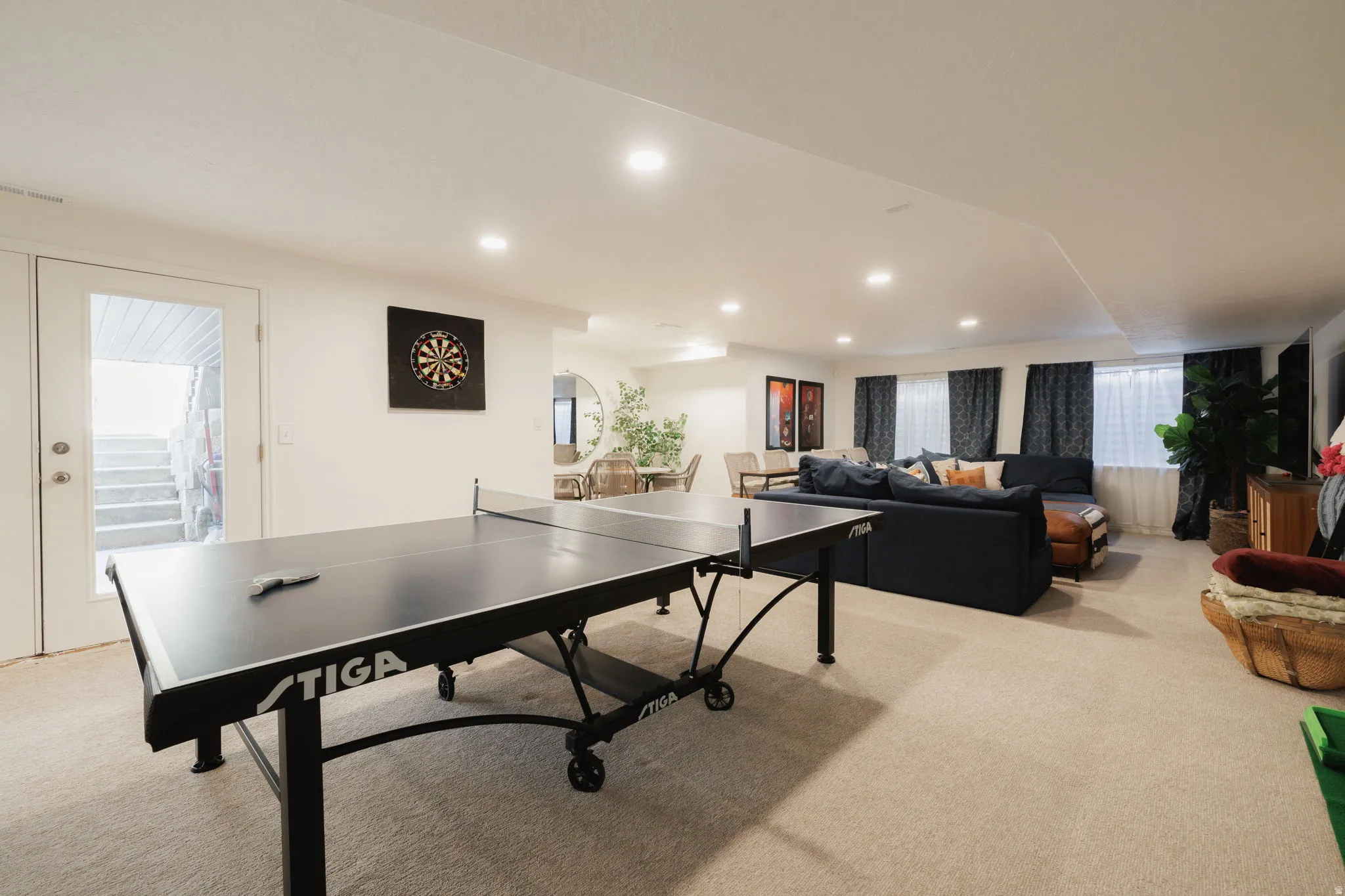 Rec room with light carpet, recessed lighting, and arched walkways