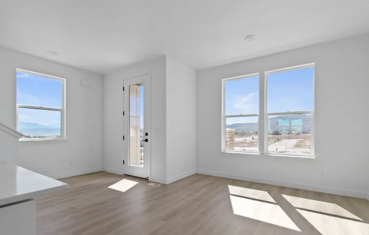 Bright interior space featuring light wood-finish flooring, white walls, and recessed lighting