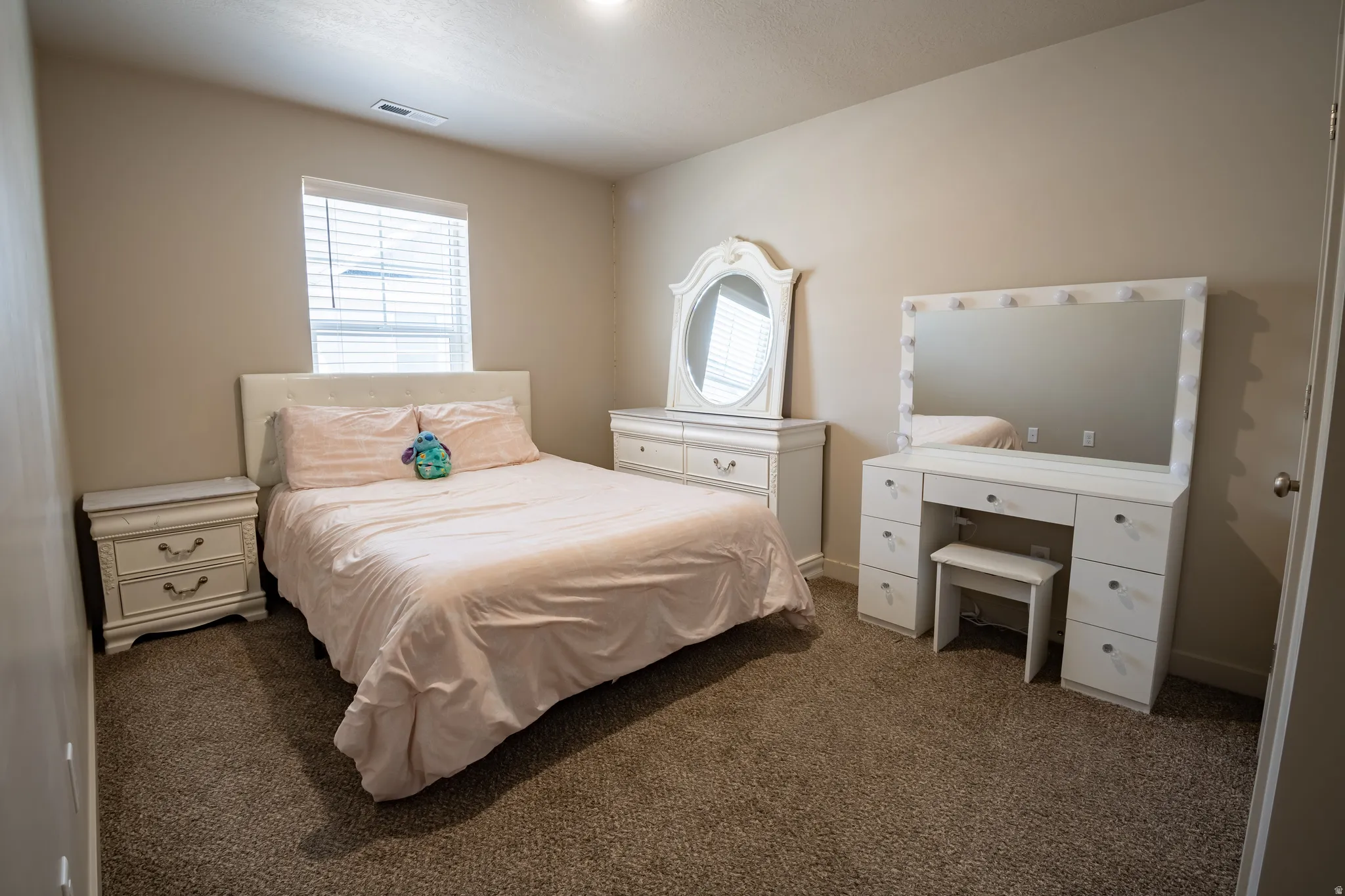 Bedroom featuring neutral-toned walls, recessed lighting, and carpeted flooring