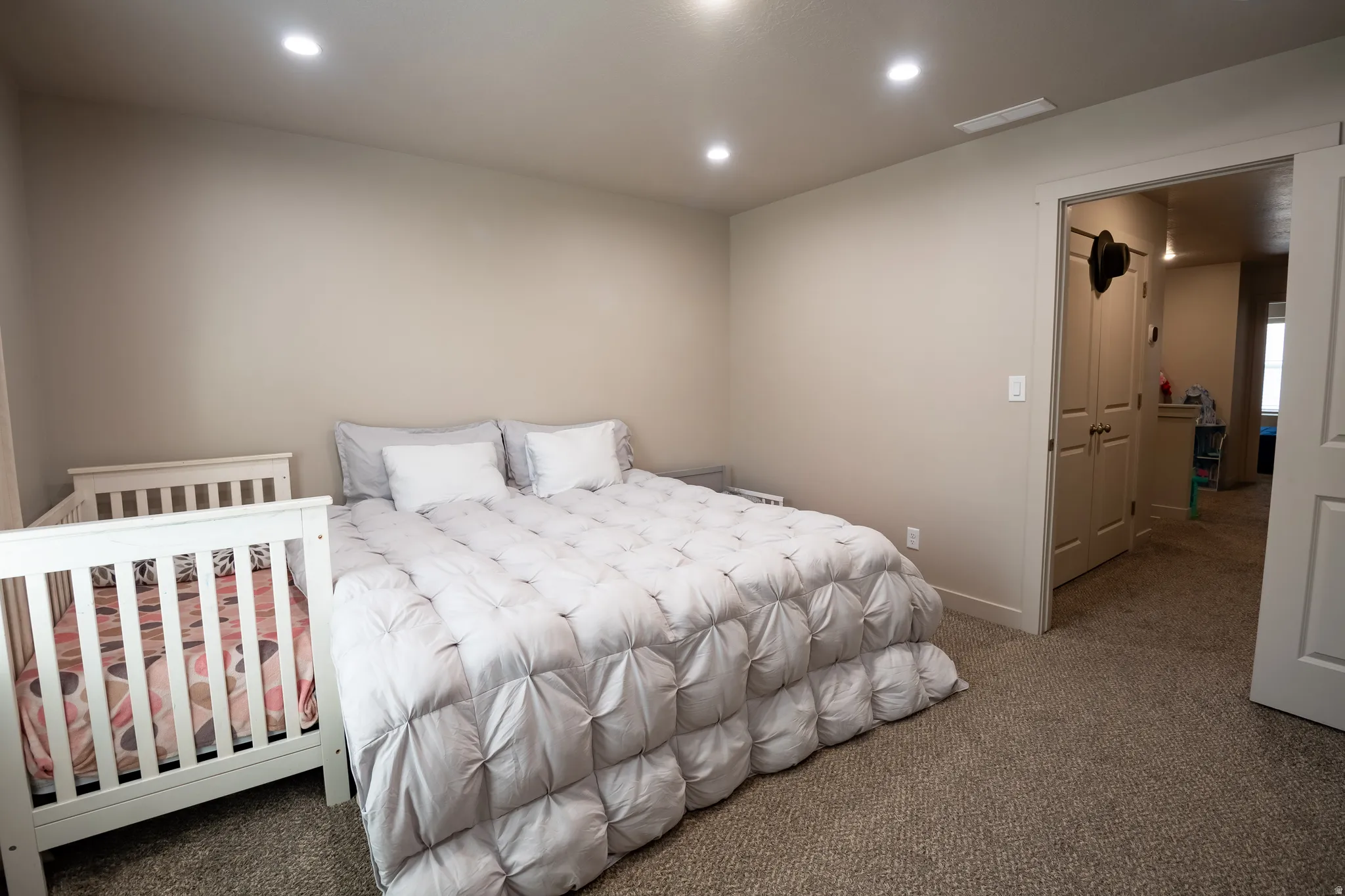 Neutral-toned bedroom featuring recessed lighting and carpeted flooring