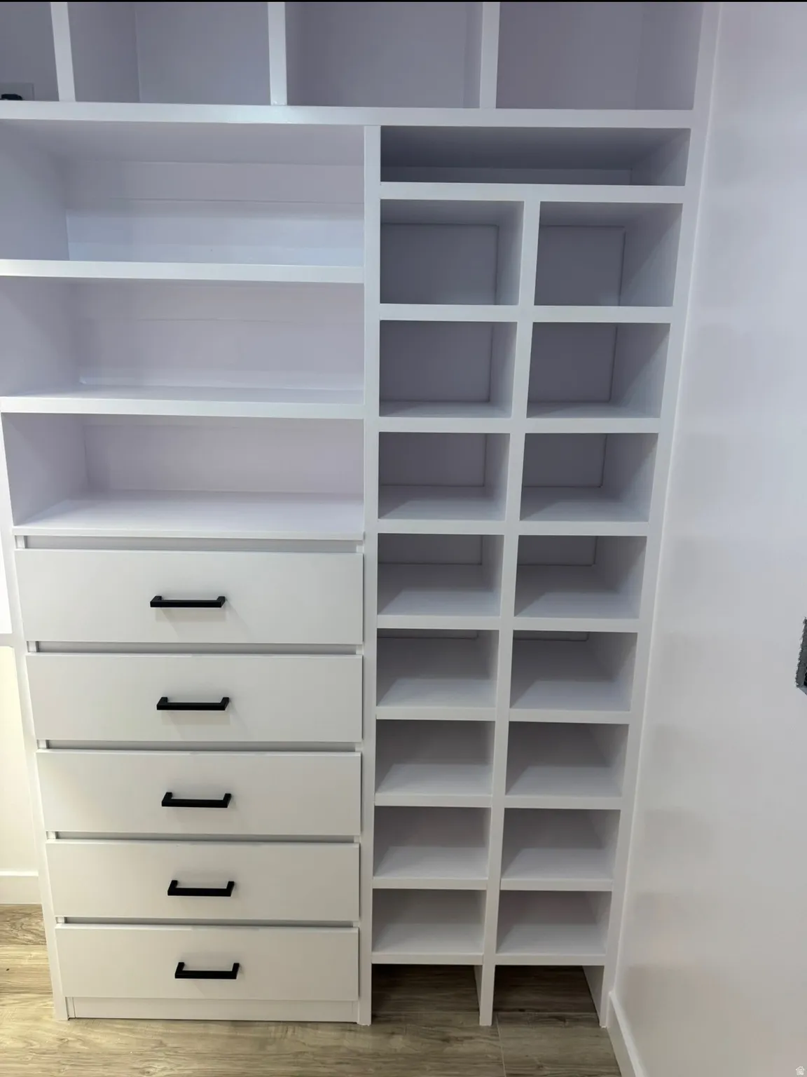 Built-in white cabinetry featuring multiple shelving configurations
