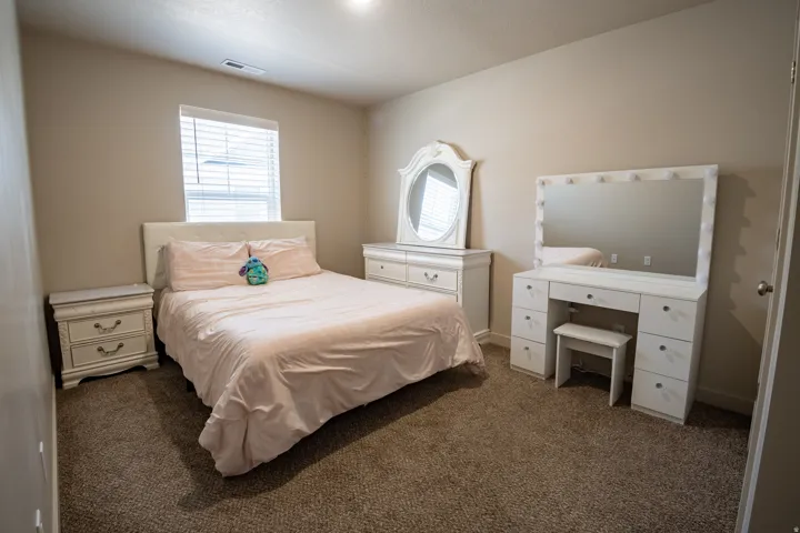 Bedroom featuring neutral-toned walls, recessed lighting, and carpeted flooring