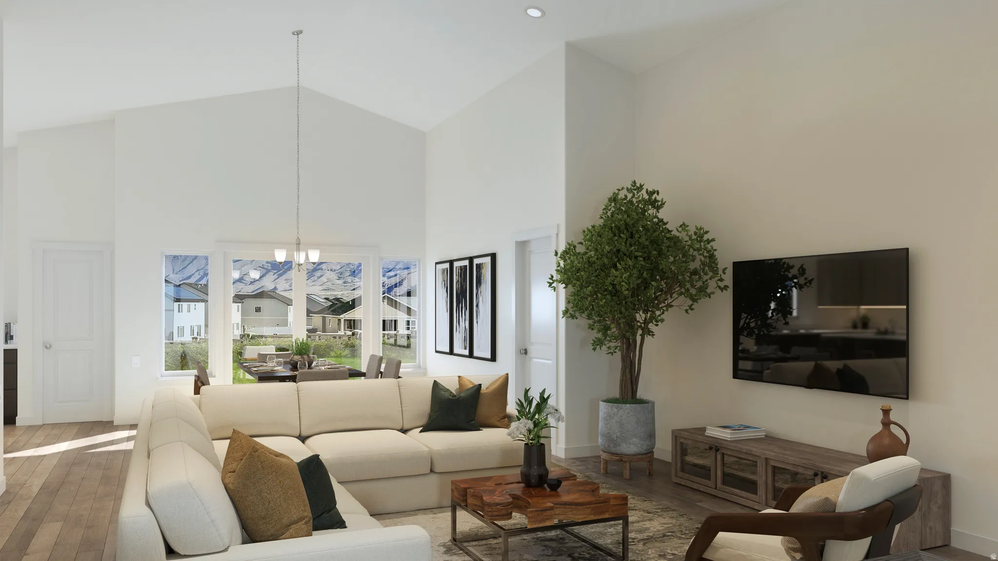 Vaulted ceilings enhance this open-concept room featuring wood-finish flooring, a contemporary chandelier, and large windows providing abundant natural light