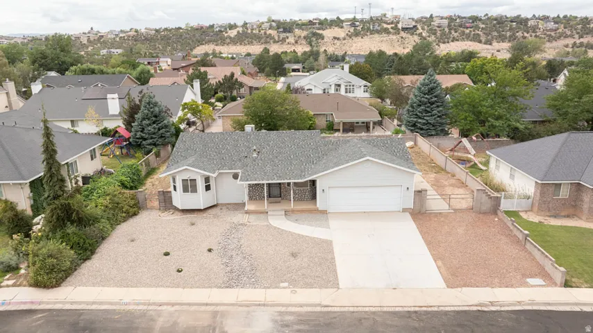Single-story residence featuring a two-car garage, bay window, and a mixed material exterior