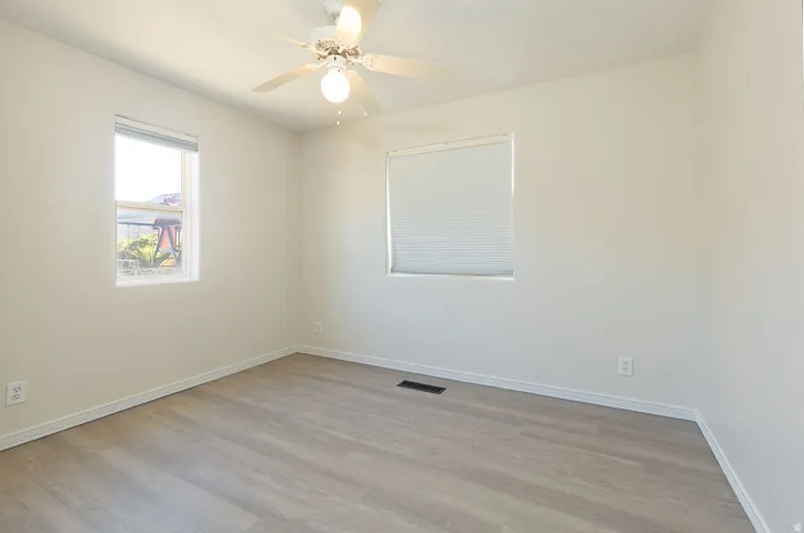 Interior room featuring light wood-finish flooring and neutral wall tones