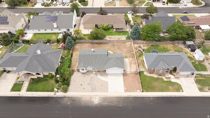 Single-story residence with a gray shingle roof, attached garage, and a concrete driveway