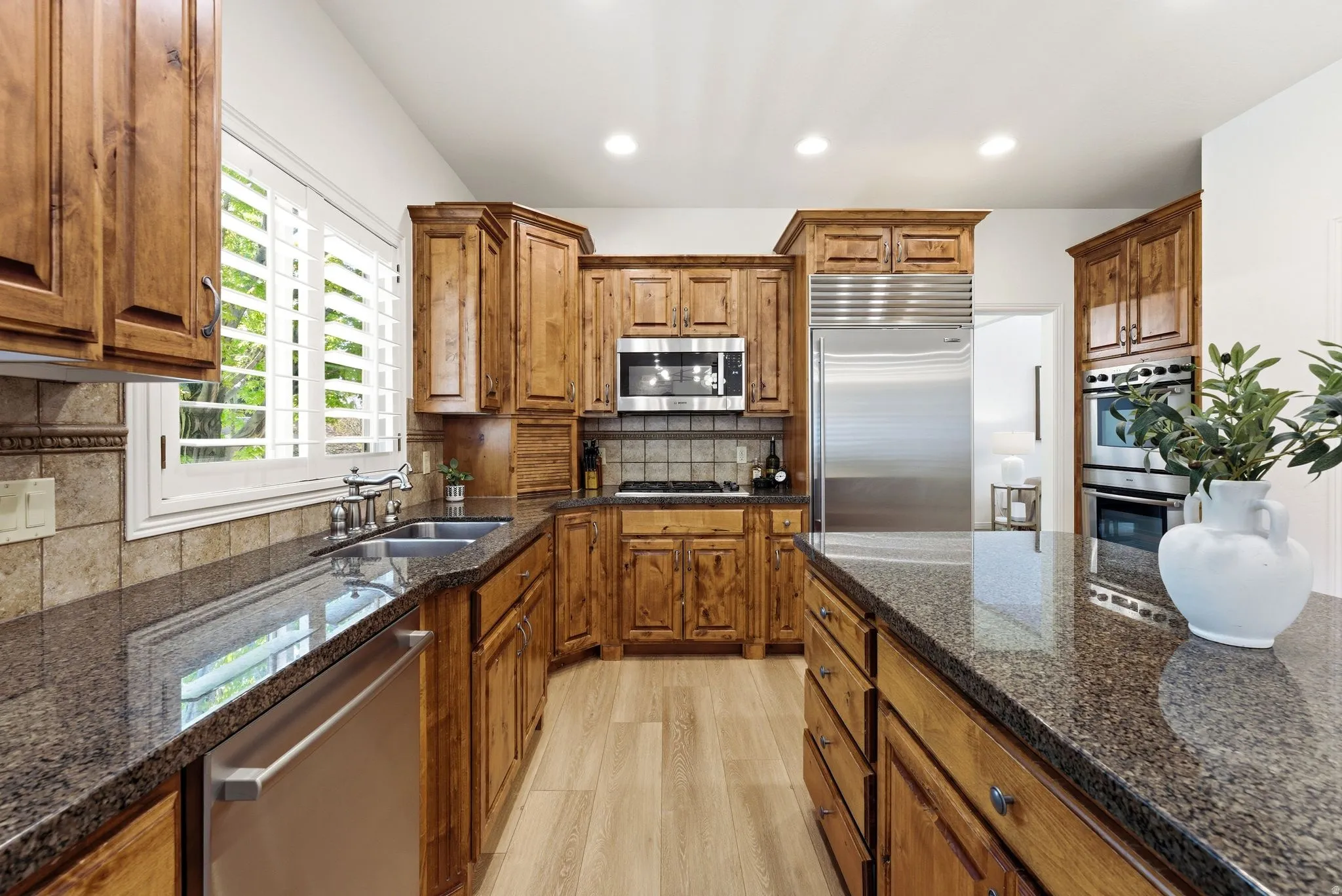Kitchen with wood-finish flooring and recessed lighting