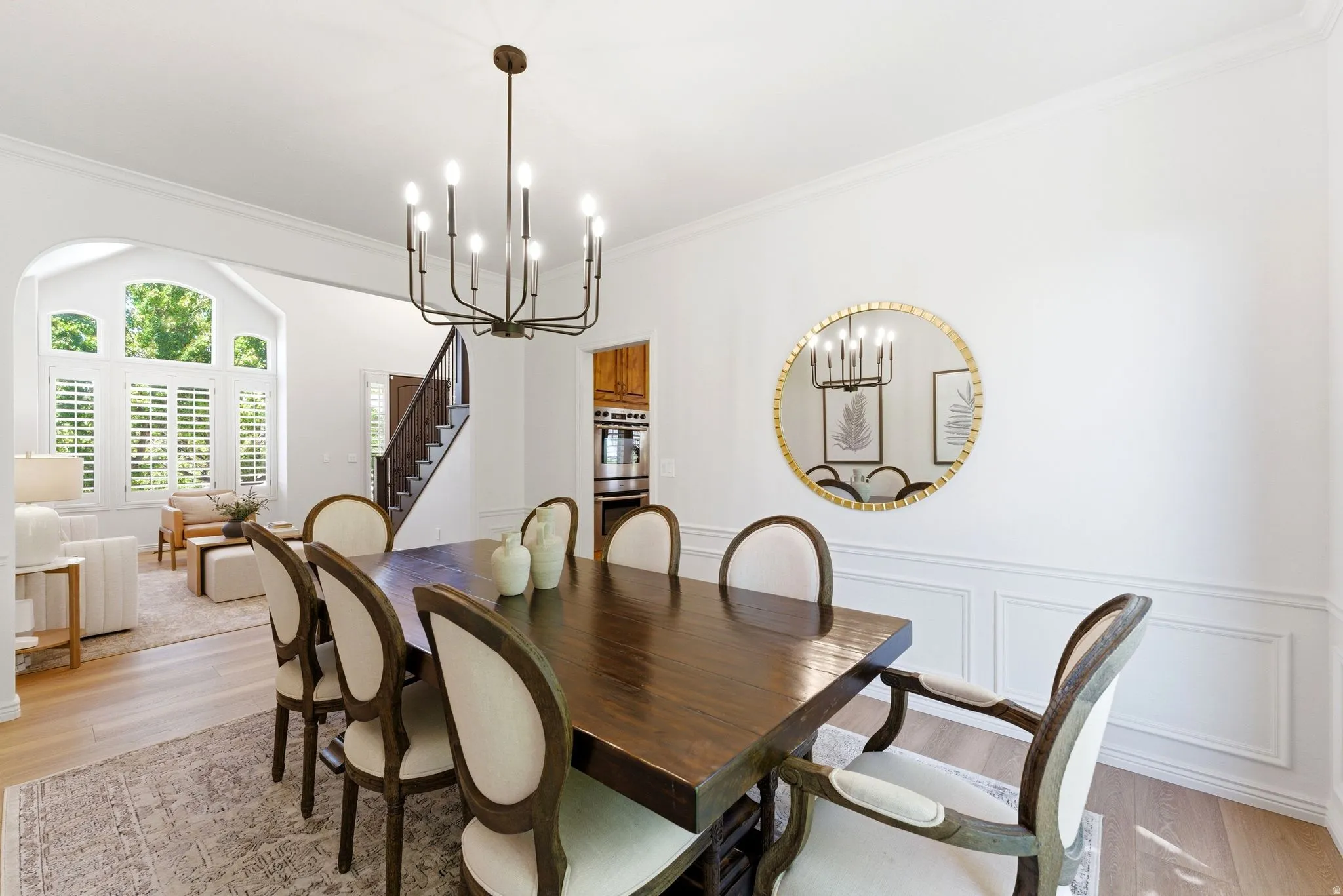 Dining area featuring light wood-finish flooring and a contemporary chandelier