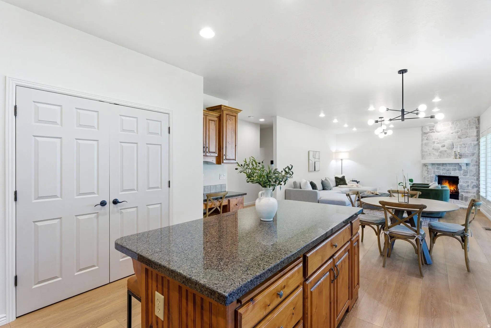 Kitchen island with granite-finish countertop and wood cabinetry
