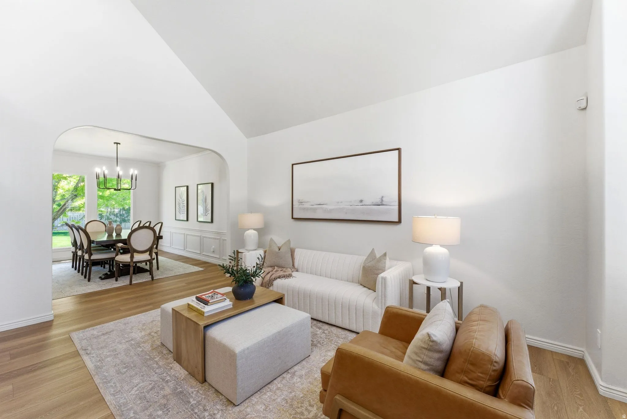 Vaulted ceilings and wood-finish flooring define this living space