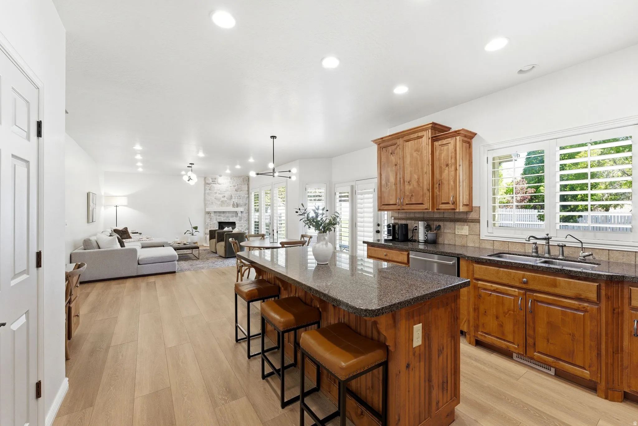 Open-concept kitchen and living area featuring wood-finish flooring