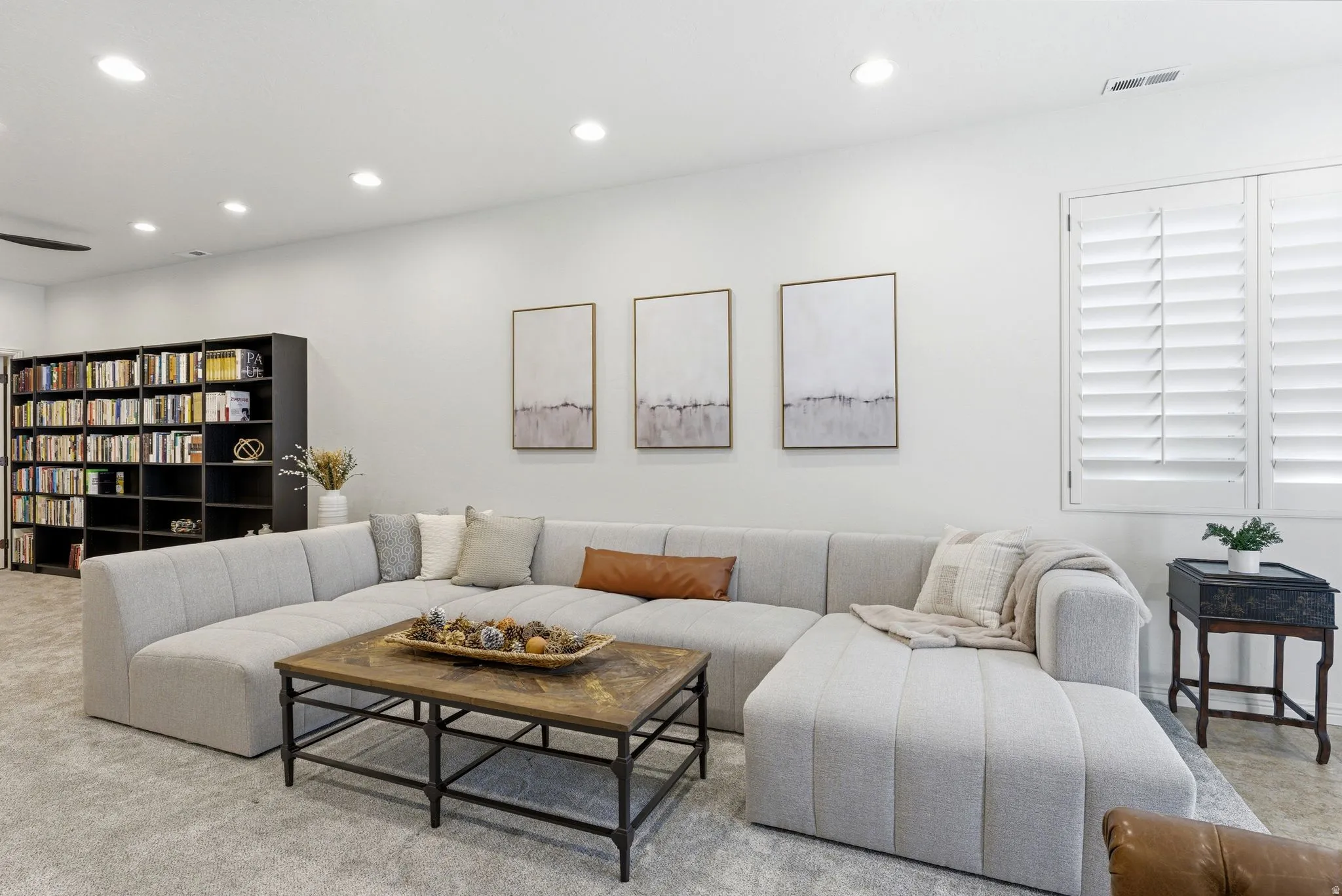 Bright entertainment room featuring recessed lighting and plush carpeting