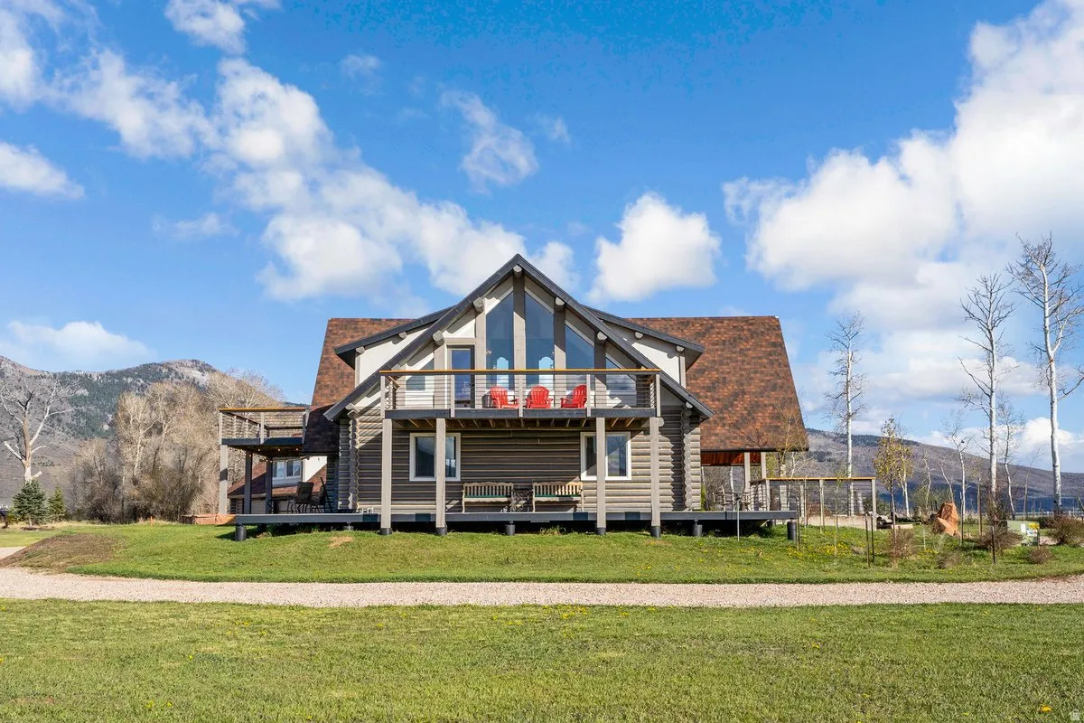 Log-sided residence featuring a prominent A-frame structure with large windows